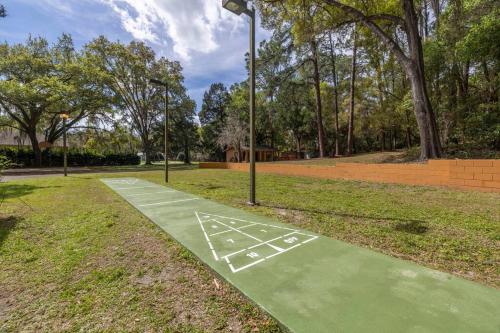 a basketball court in a park with trees at Rainbow River Estate on Blue Run in Dunnellon