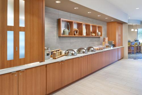 a kitchen with wooden cabinets and a counter top at SpringHill Suites by Marriott Arlington TN in Arlington