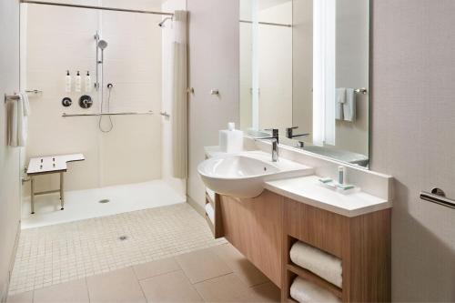 a white bathroom with a sink and a shower at SpringHill Suites by Marriott Arlington TN in Arlington