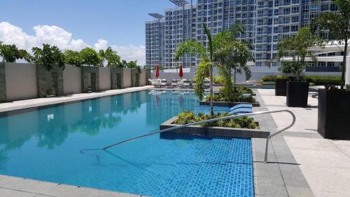a large swimming pool in the middle of a building at One Pacific Residences by Hiverooms in Lapu Lapu City