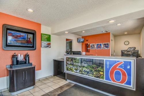 a fast food restaurant with a sign on the wall at Motel 6-Stockton, CA - Charter Way West in Stockton