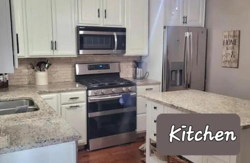 a kitchen with a stove and a refrigerator at Cozy Cottage in Louisville in Louisville