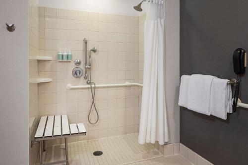 a bathroom with a shower with a shower curtain at Courtyard Long Beach Airport in Long Beach