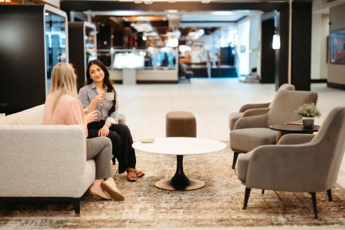 two women sitting on chairs in a store at Halifax Marriott Harbourfront Hotel in Halifax
