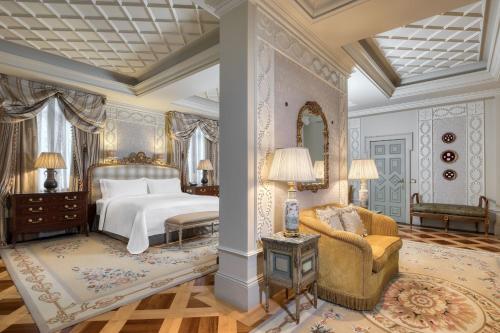 a bedroom with a bed and a couch and a chair at Hotel Grande Bretagne, a Luxury Collection Hotel, Athens in Athens