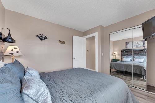a bedroom with a bed and a large mirror at Branson Pointe Royale condo-Table Rock lake-free golf in Branson