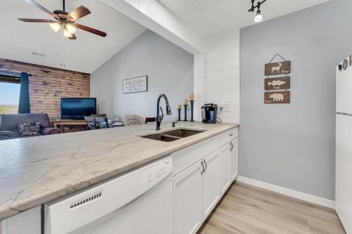 a kitchen with a sink and a counter top at Branson Pointe Royale condo-Table Rock lake-free golf in Branson