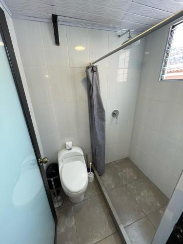 a bathroom with a toilet and a shower at Net House Cusco in Cusco
