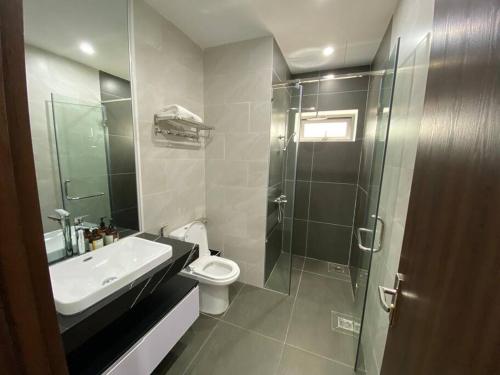 a bathroom with a sink and a toilet and a shower at Regal Victoria luxury villa in Trà Khê (1)