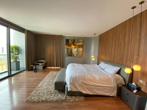 a bedroom with a bed and a couch in it at Regal Victoria luxury villa in Trà Khê (1)