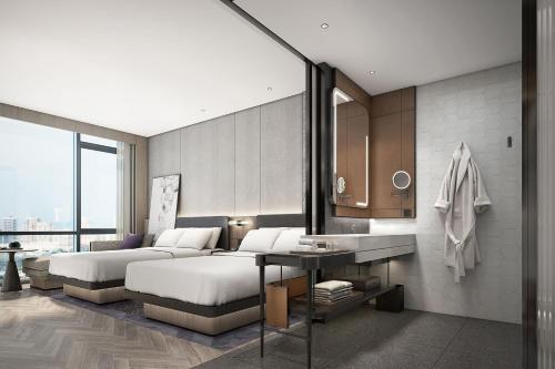 a hotel room with two beds and a table at AC Hotel by Marriott Chengdu North in Chengdu