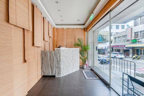 a lobby of a building with a counter and a window at Penghu Chin Style Inn in Magong