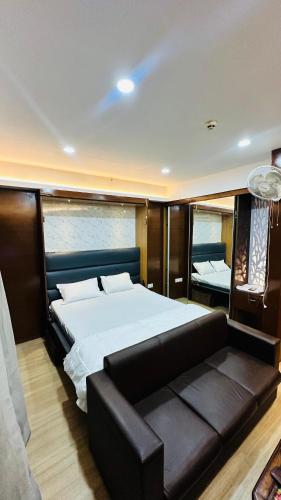 a bedroom with a large bed and a couch at Star Comfort Inn in Lucknow