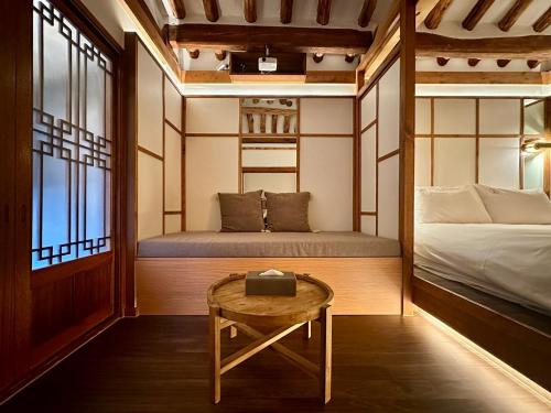 a small room with a bed and a table at Luxury hanok with private bathtub - SN03 in Seoul