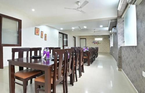 a dining room with a long table and chairs at the indigo premium in Noida