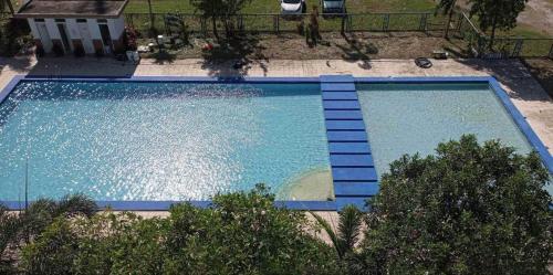 an overhead view of a large blue swimming pool at Blue Diamond Staycation beside Enchanted Kingdom in Santa Rosa