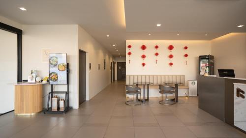 a lobby of a restaurant with two tables and chairs at The Rise Suites Hotel, Chiang Mai - SHA Extra Plus in Chiang Mai