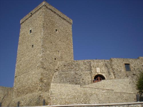a tall stone building with a blue sky in the background at Colle d'Elce in Deliceto