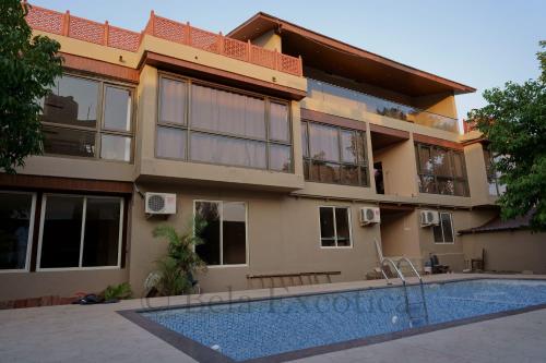 a house with a swimming pool in front of it at Bela exotica in Mahabaleshwar