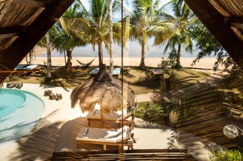 an overhead view of a resort with a pool and palm trees at The Beach House Ocam Ocam in Busuanga