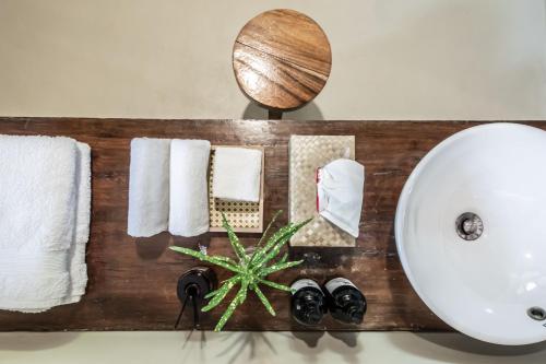 a bathroom counter with towels and a sink at The Beach House Ocam Ocam in Busuanga