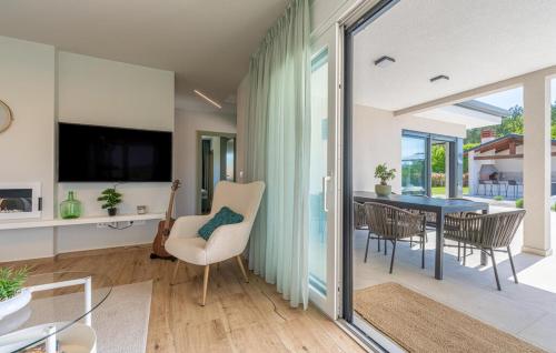a living room with a table and chairs at Villa Green Forest with wellness and heated salty pool in Hum