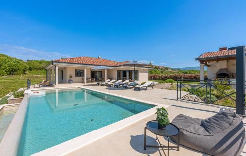 a swimming pool in front of a house at Villa Green Forest with wellness and heated salty pool in Hum