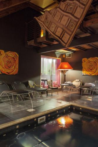 a room with a swimming pool and a living room at Adua & Regina di Saba Wellness & Beauty in Montecatini Terme