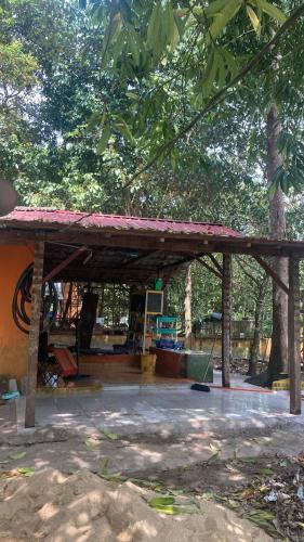 a pavilion in a park with trees in the background at Campsite House In a Farm in Cukai