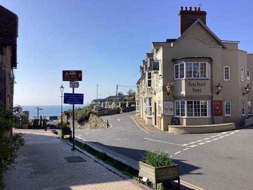 an empty street with a building on the side of the road at Sea Haven in Seaton