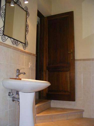 a bathroom with a white sink and a mirror at Casa Marchi in Bagni di Lucca