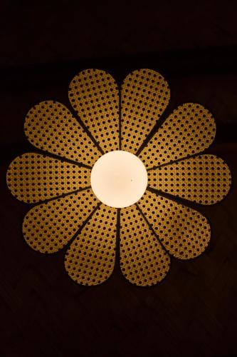 a ceiling light with a flower design on it at The Beach House Ocam Ocam in Busuanga