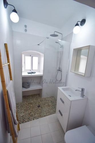 a bathroom with a toilet and a sink and a mirror at Casa Pomelo, Frigiliana Luxury center townhouse with pool and parking HansOnHoliday Rentals in Frigiliana