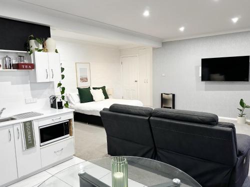 uma sala de estar com um sofá e uma cama em Sheer Pleasure Accommodation em Smithton