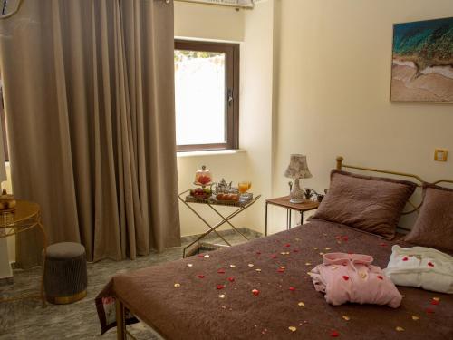 a bedroom with a bed with flowers on it at Aphrodite View in Korakiaí