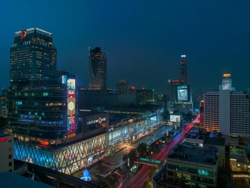 a city lit up at night with buildings at Grand Hyatt Erawan Bangkok in Bangkok