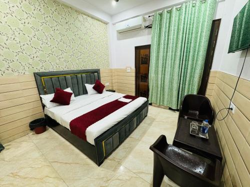 a bedroom with a bed with red pillows on it at Hotel Sapphire Grand - Onyx Plaza in Ghaziabad