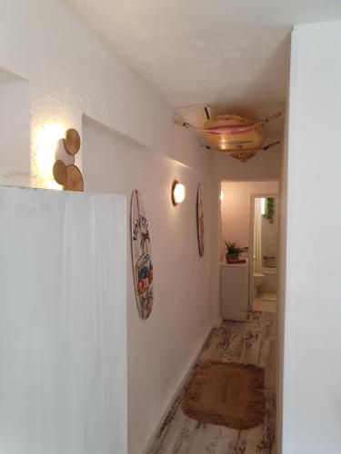 a hallway of a home with a white wall at apartamento playa surf cullera in Cullera
