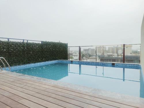 a swimming pool on the roof of a building at Cygnett Style Ganga in Jaipur