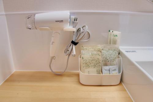 a hair dryer sitting on the floor in a kitchen at Island Stay Izumizaki Hotel in Naha