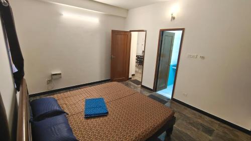 a room with a table with a blue napkin on it at HACIENDA APARTMENT in Chennai