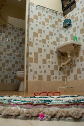 a bathroom with a sink and a rug on the floor at Ultimate Elegance in Embu