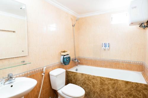 a bathroom with a tub and a toilet and a sink at Old Quarter Autumn To Tich Ha Noi in Hanoi