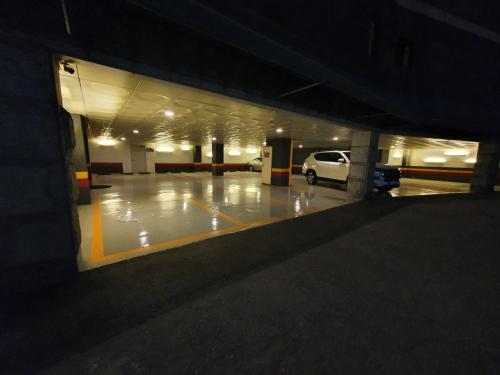 an empty parking garage with a car parked in it at 호텔여행 in Incheon