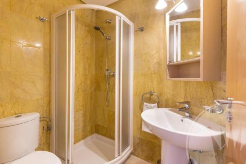 a bathroom with a shower and a toilet and a sink at Mar Menor Golf Resort - 117 in Las Casicas