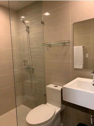 a bathroom with a shower and a toilet and a sink at One Pacific Residences by Hiverooms in Lapu Lapu City