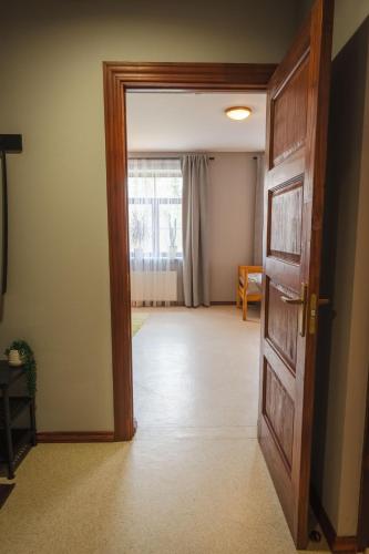 an open door into a living room with a window at Barona spilvens in Kazdanga