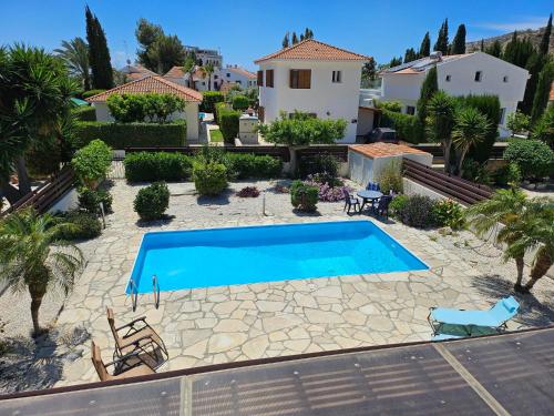 a swimming pool in front of a house at Villa Penny in Pissouri
