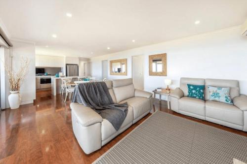 a living room with a couch and a table at Hallett Cove Hideaway By Host Solutions in Halletts Cove
