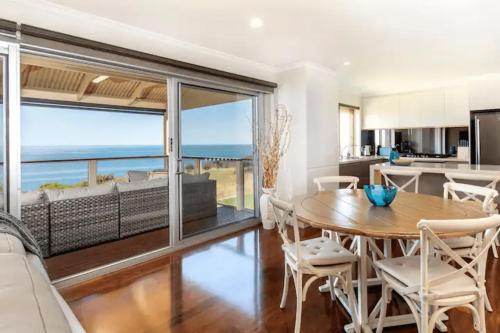 a kitchen and dining room with a view of the ocean at Hallett Cove Hideaway By Host Solutions in Halletts Cove